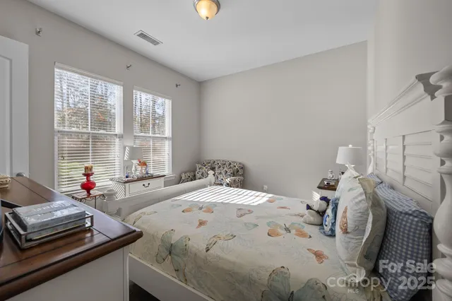 a bedroom with a bed and a couch