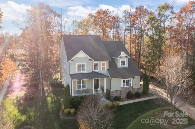 an aerial view of a house with a yard