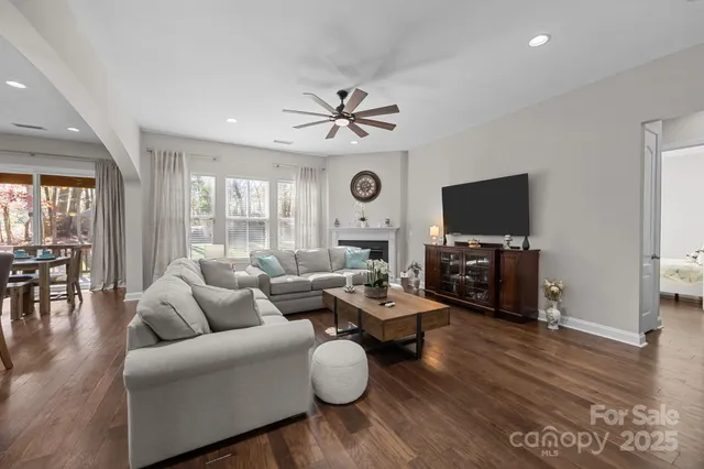 a living room with furniture a fireplace and a flat screen tv