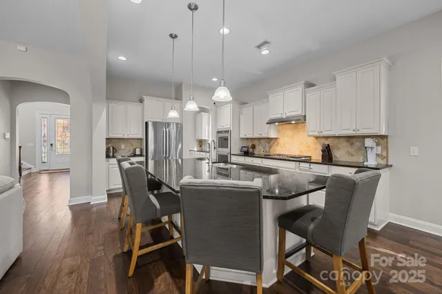 a kitchen with counter top space a sink wooden cabinets and stainless steel appliances