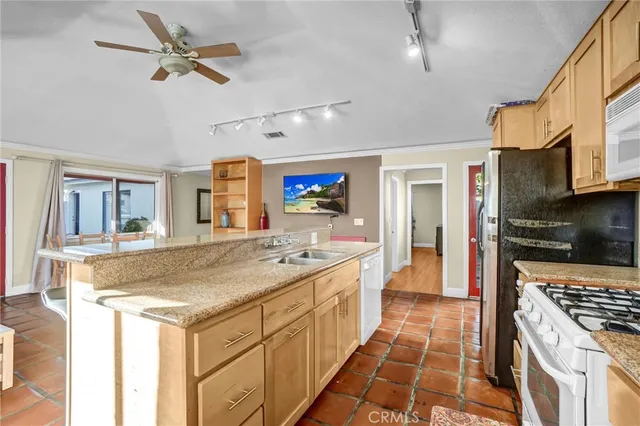 a kitchen with stainless steel appliances granite countertop a sink and cabinets