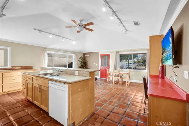 a open kitchen with stainless steel appliances kitchen island granite countertop a sink and cabinets