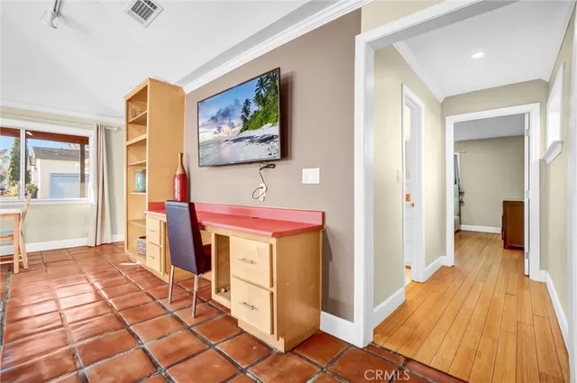 a view of a hallway with wooden floor and furniture