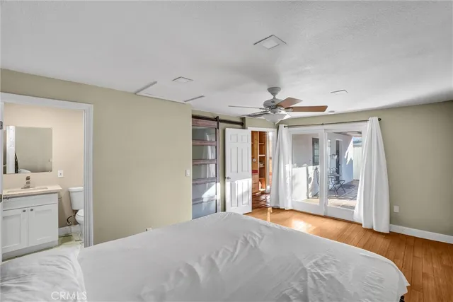 a bathroom with a shower sink vanity and toilet