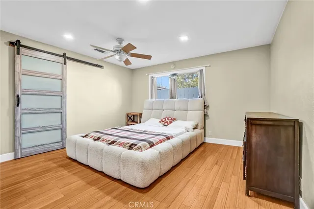 a bedroom with a bed and ceiling fan