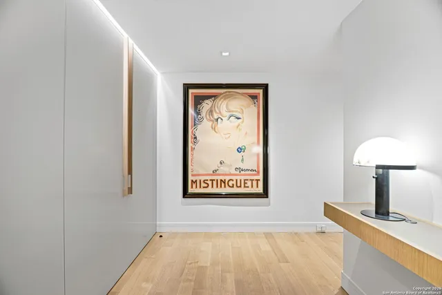 a view of a hallway with paintings on the wall