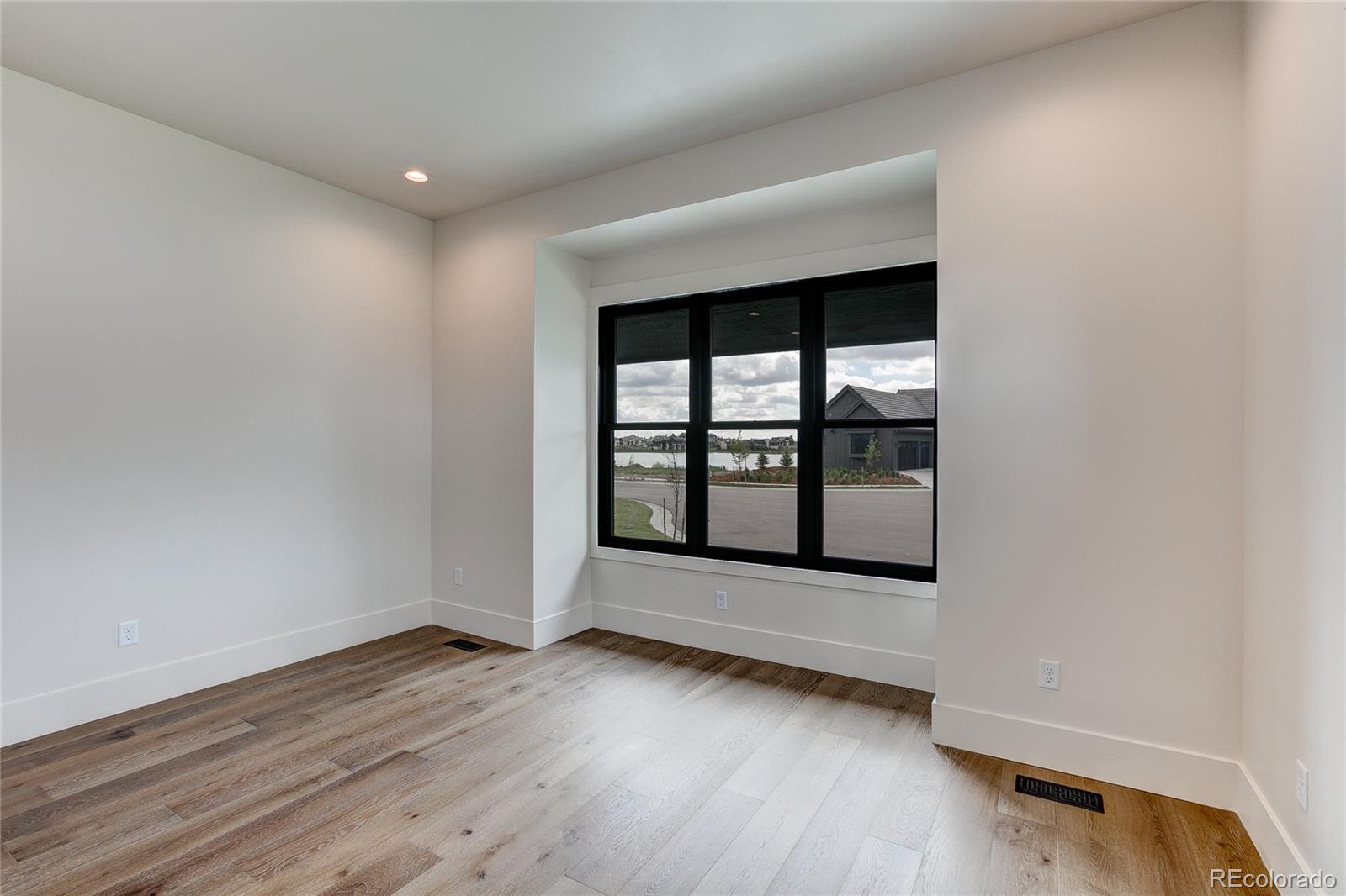 2531 Southwind Road Berthoud, CO 80513 - Photo 17 of 33 an empty room with wooden floor and windows