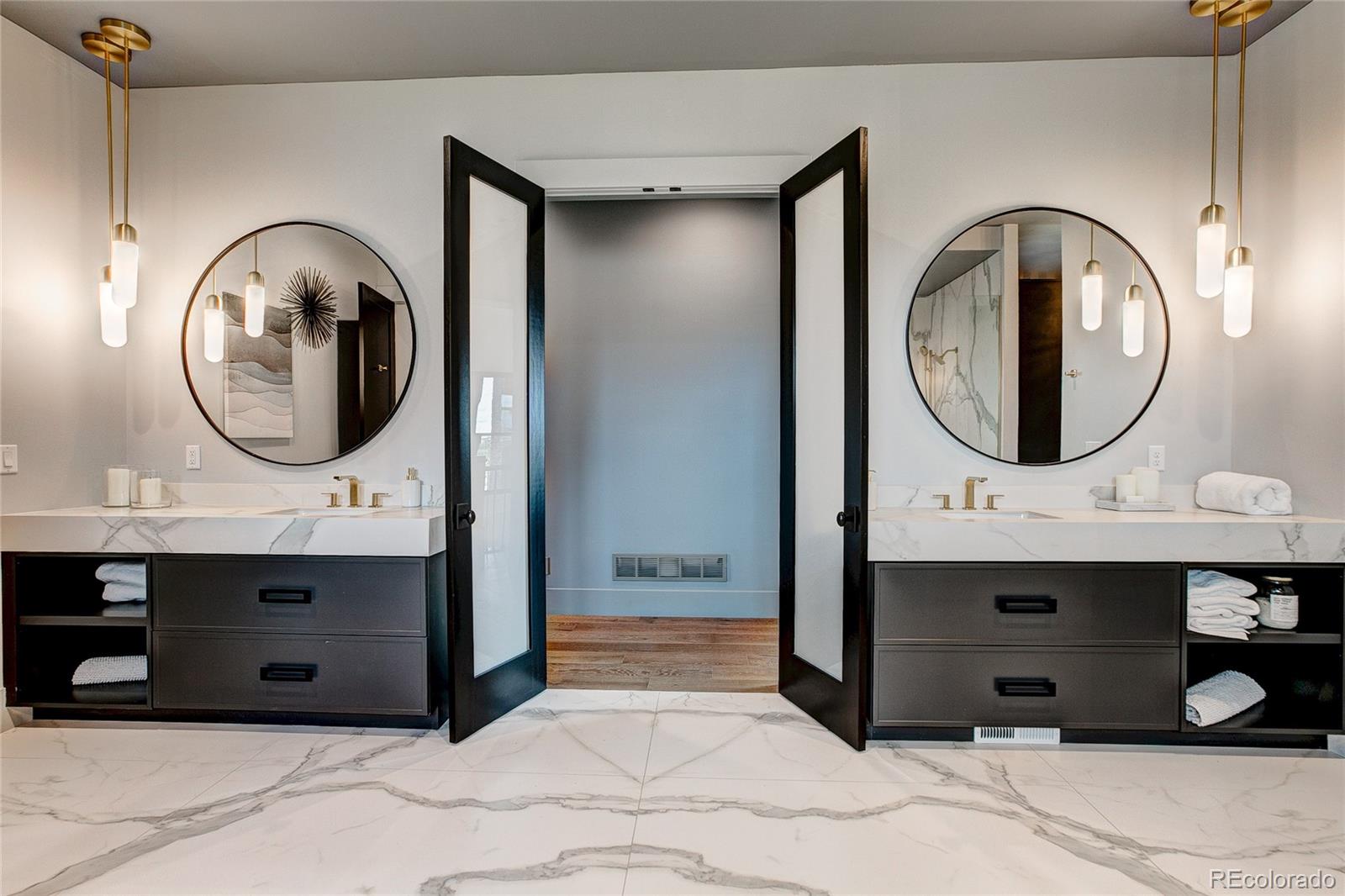 2531 Southwind Road Berthoud, CO 80513 - Photo 21 of 33 a bathroom with a sink a mirror and a shower