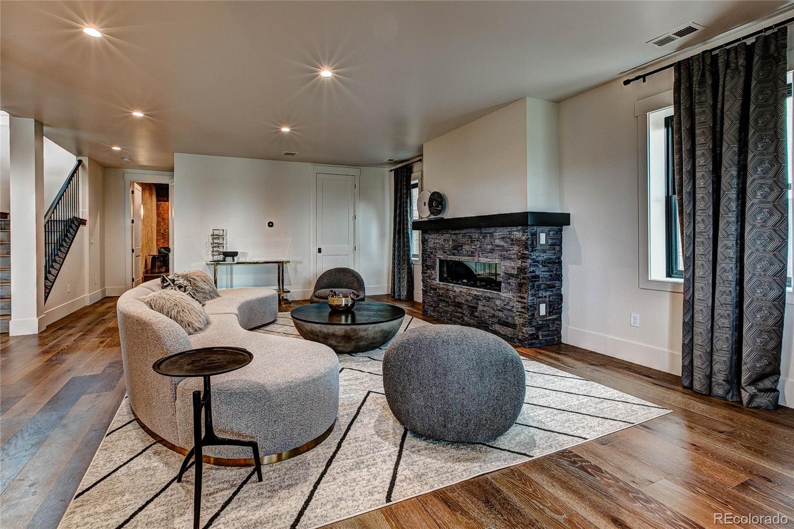 2531 Southwind Road Berthoud, CO 80513 - Photo 28 of 33 a living room with furniture a fireplace and a flat screen tv