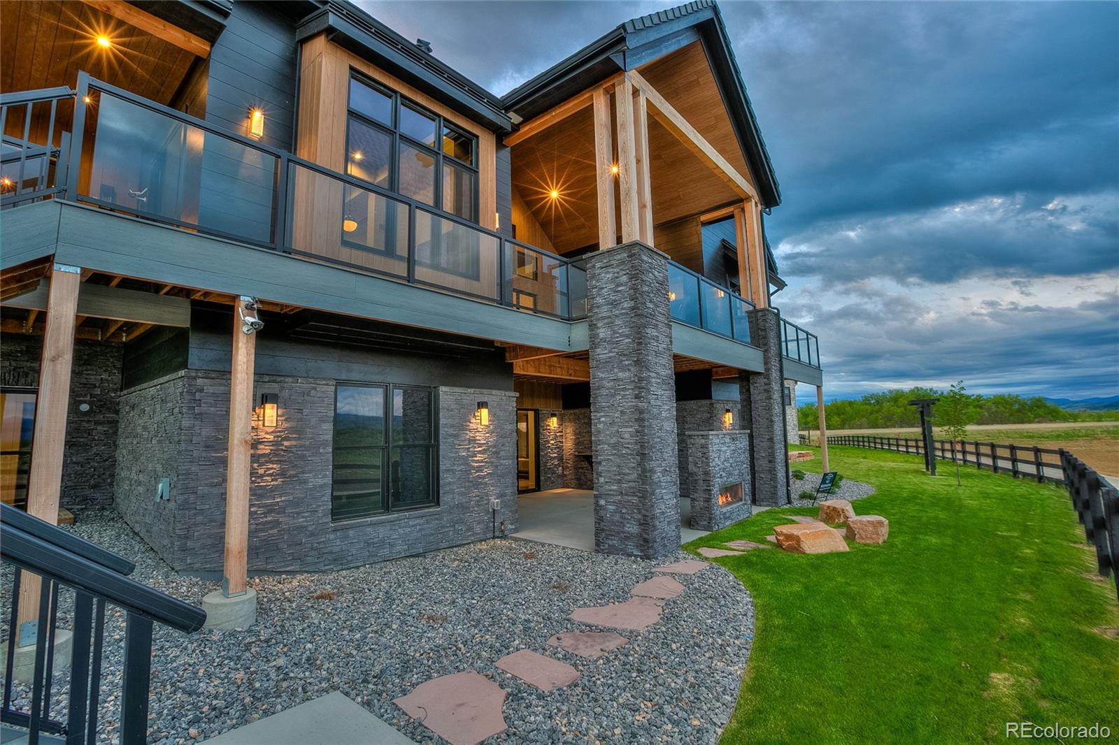 2531 Southwind Road Berthoud, CO 80513 - Photo 32 of 33 a view of a brick house with a yard and plants