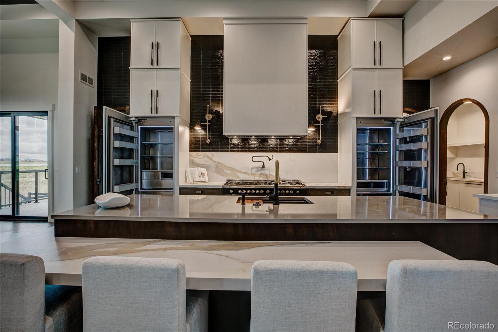 2531 Southwind Road Berthoud, CO 80513 - Photo 9 of 33 a kitchen with kitchen island granite countertop a table and chairs in it
