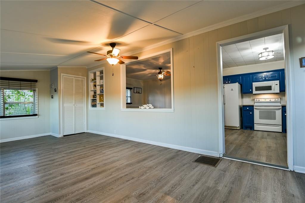 458 Haley Road Jackson, GA 30233 - Photo 6 of 47 a view of a kitchen with an empty room wooden floor and a kitchen