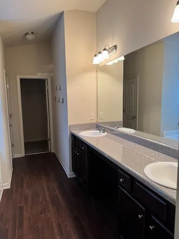 a bathroom with a double vanity sink and a mirror