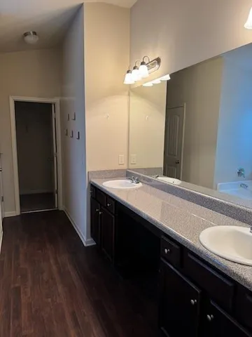 a bathroom with a double vanity sink and a mirror