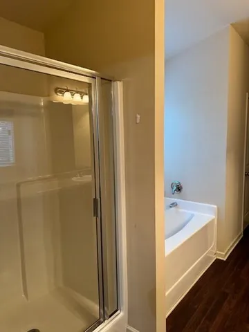 a bathroom with a tub and shower