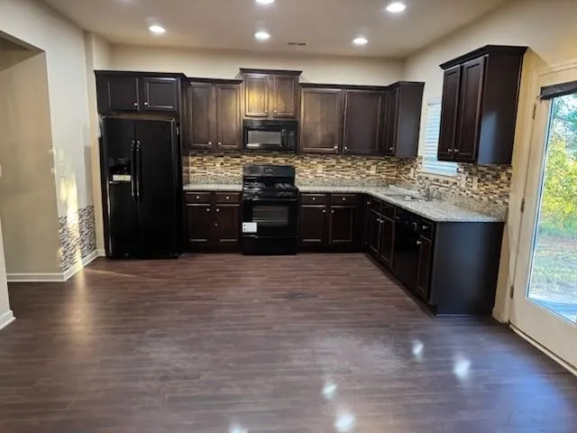 a kitchen with stainless steel appliances granite countertop a refrigerator and a granite counter tops