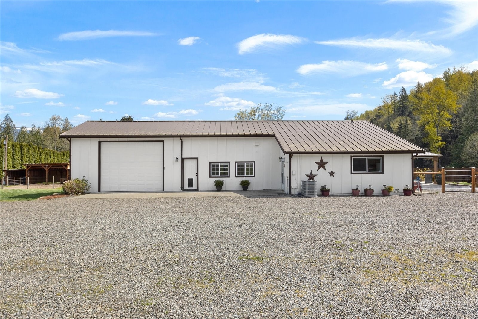 35124 Mann Road Sultan, WA 98294 - Photo 3 of 40 a front view of a house with a dirt yard and garage
