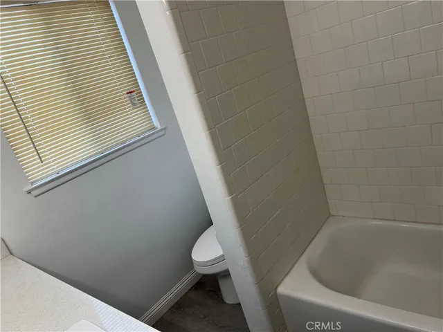 a bathroom with a bathtub and toilet