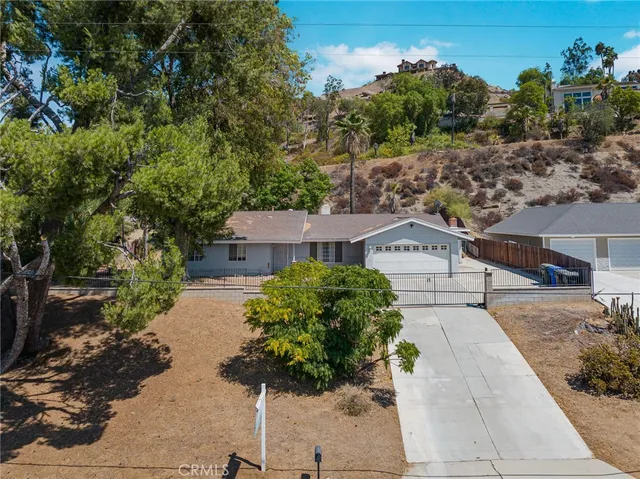 a picture of a house with a yard and garden