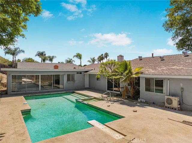 a view of a house with backyard porch and sitting area