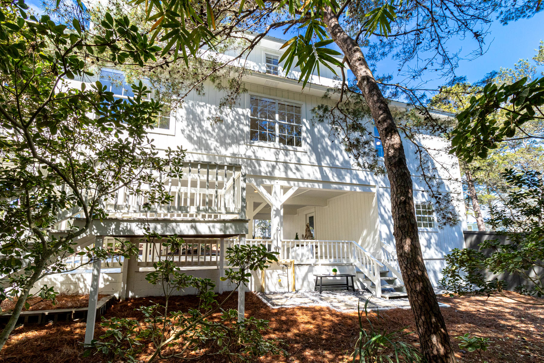 86 Crescent Road Santa Rosa Beach, FL 32459 - Photo 22 of 62 a balcony with table and chairs and a fire pit