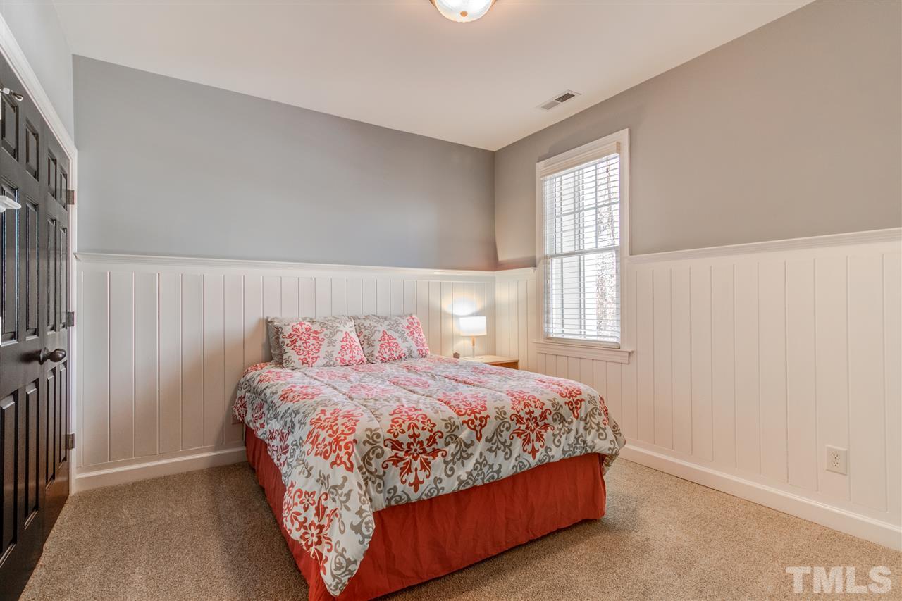 816 Cotton Exchange Court Raleigh, NC 27608 - Photo 15 of 25 a bedroom with a bed lamp and window