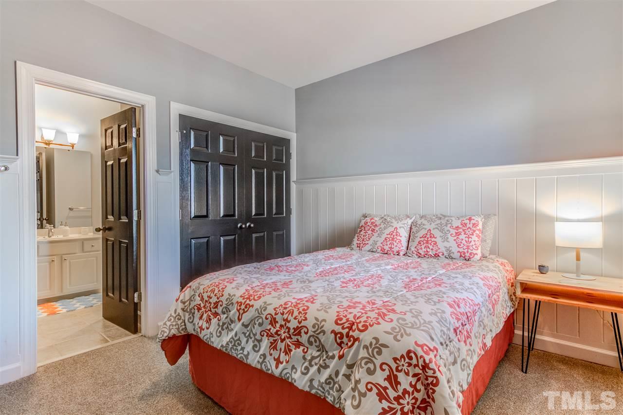 816 Cotton Exchange Court Raleigh, NC 27608 - Photo 16 of 25 a spacious bedroom with a bed and a refrigerator
