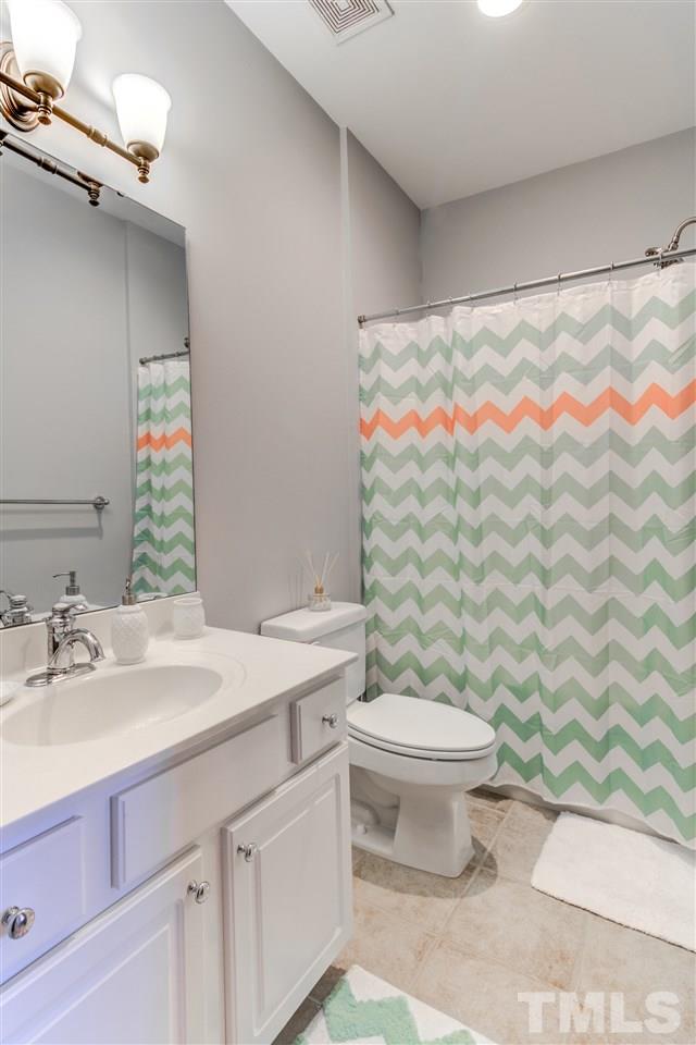816 Cotton Exchange Court Raleigh, NC 27608 - Photo 17 of 25 a bathroom with a sink and a toilet