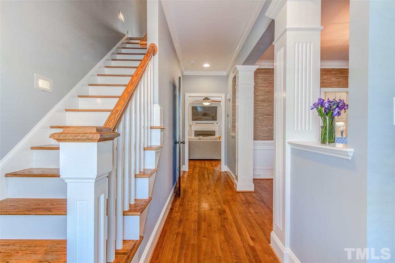 816 Cotton Exchange Court Raleigh, NC 27608 - Photo 3 of 25 a view of a hallway with wooden floor and staircase