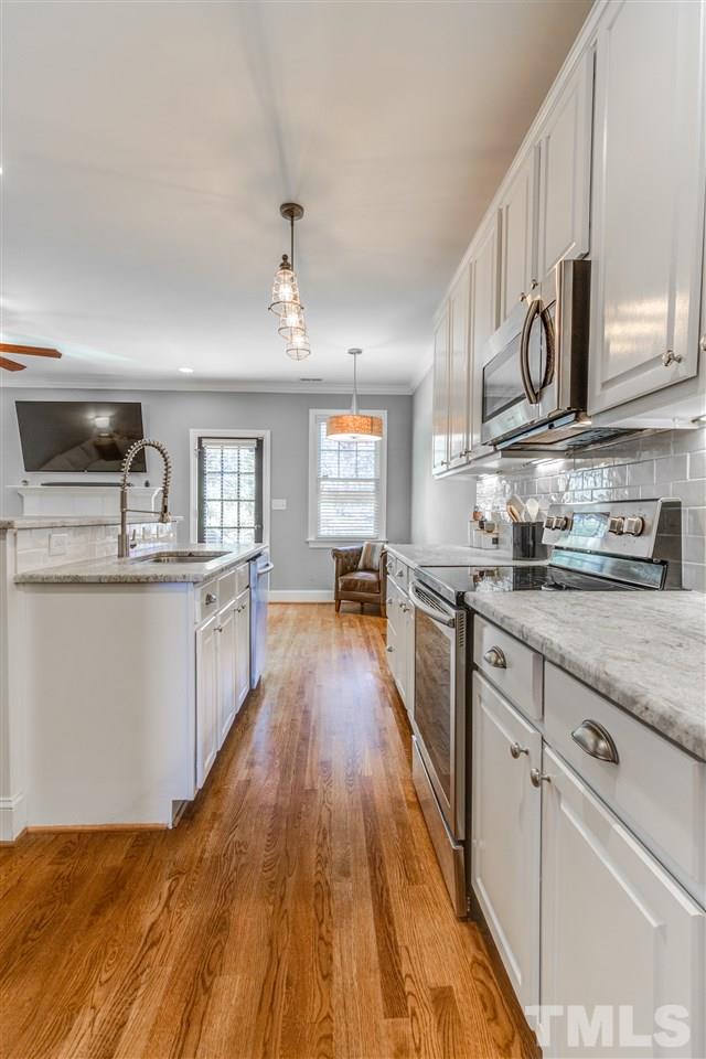 816 Cotton Exchange Court Raleigh, NC 27608 - Photo 8 of 25 a large kitchen with stainless steel appliances granite countertop a lot of counter space and wooden floors