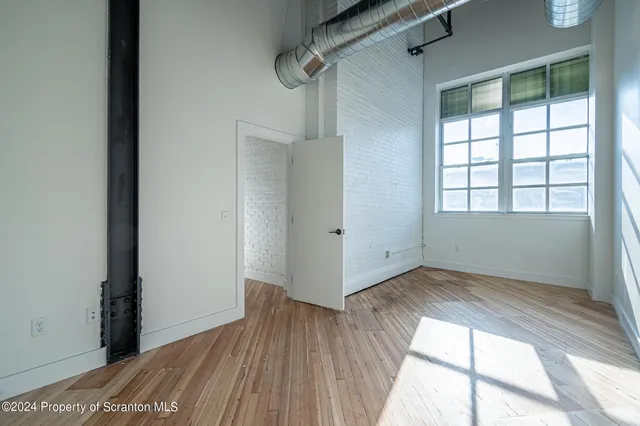 a view of a room with wooden floor