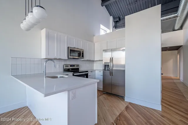 a kitchen with stainless steel appliances granite countertop a stove and a sink