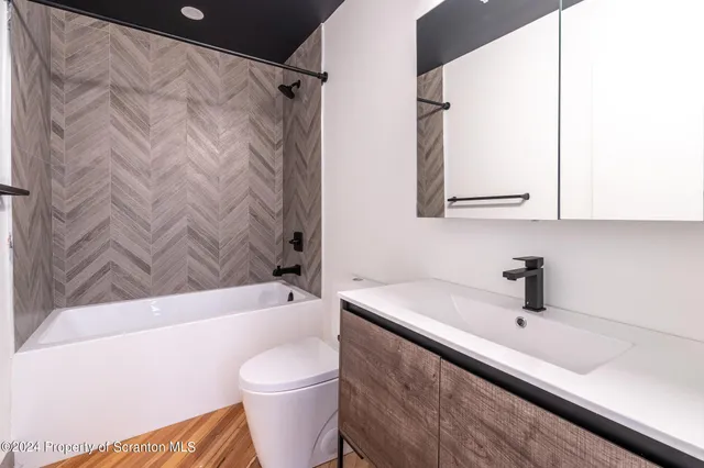 a view of a kitchen with wooden floor and a sink