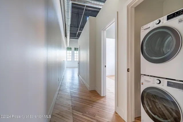a kitchen with stainless steel appliances a sink cabinets and wooden floor