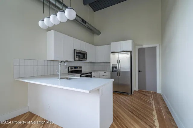 a view of a room with wooden floor