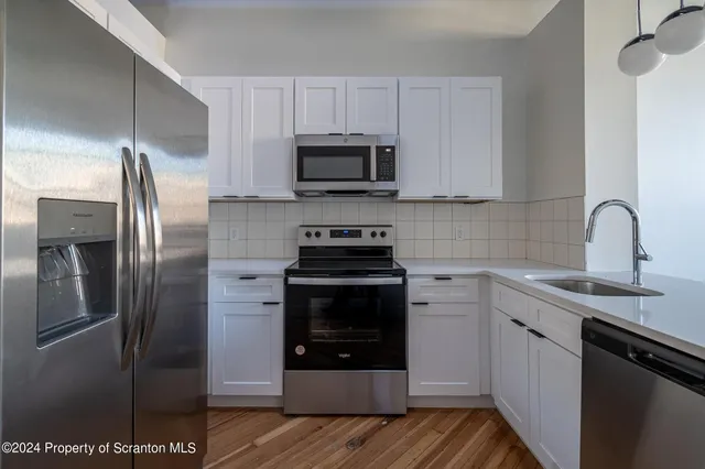 a view of kitchen with wooden floor and window