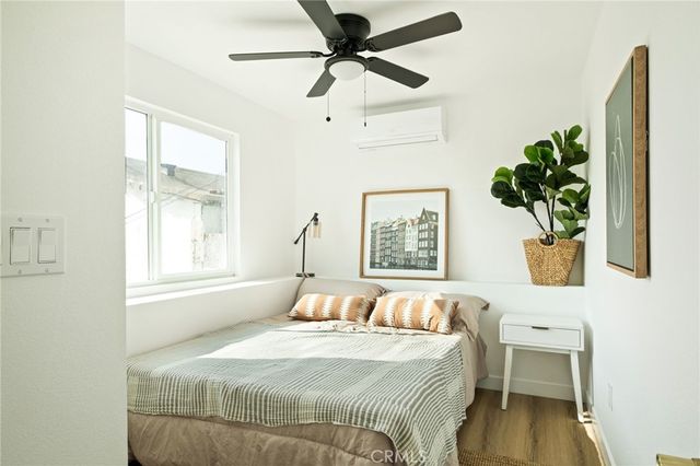 a bedroom with a bed and a window