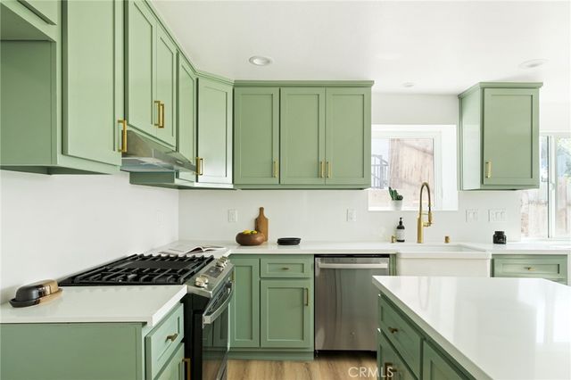 a kitchen with a sink stove and cabinets