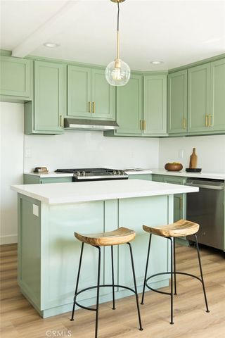 a kitchen with a sink cabinets and window