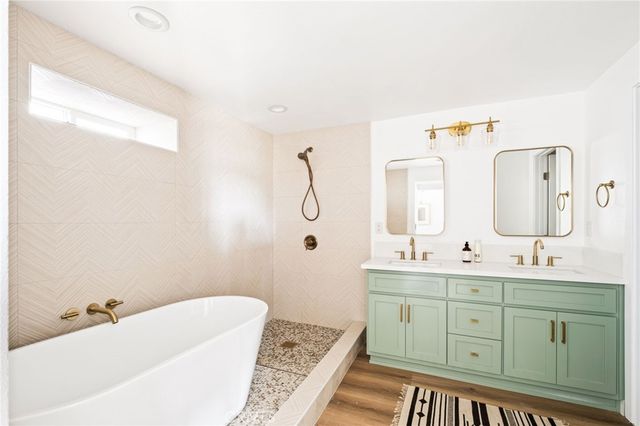 a bathroom with a sink vanity and mirror