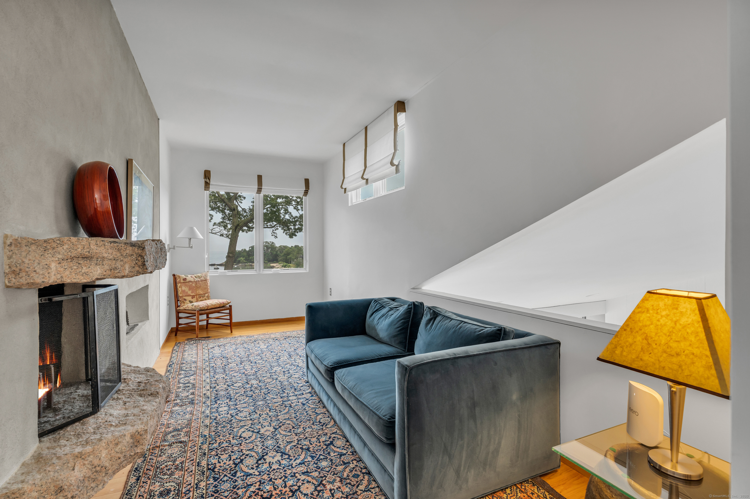 51 Andrews Road Guilford, CT 06437 - Photo 35 of 40 The Den with a cement call hosting a fireplace. Could be a wonderful office!