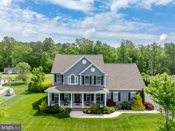 a aerial view of a house with yard and green space