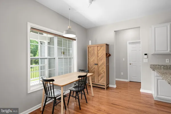a view of a dining room with furniture and wooden floor