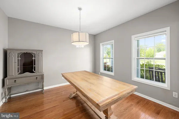 a room with pool table and windows
