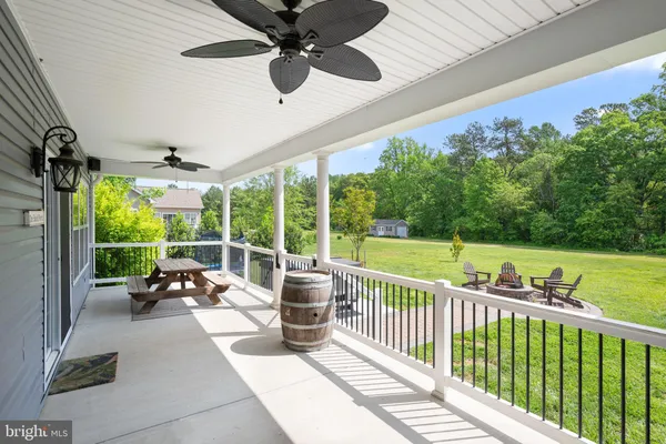 a view of a porch with furniture and garden