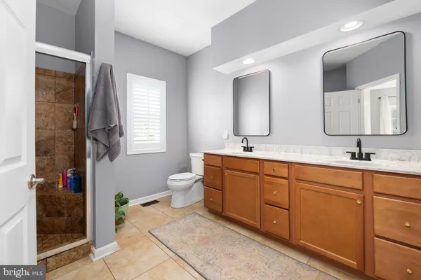 a bathroom with double vanity sinks and a mirror