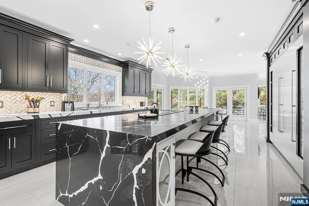 817 West Shore Drive Butler, NJ 07405 - Photo 12 of 50 a kitchen with a table chairs refrigerator and wooden cabinets