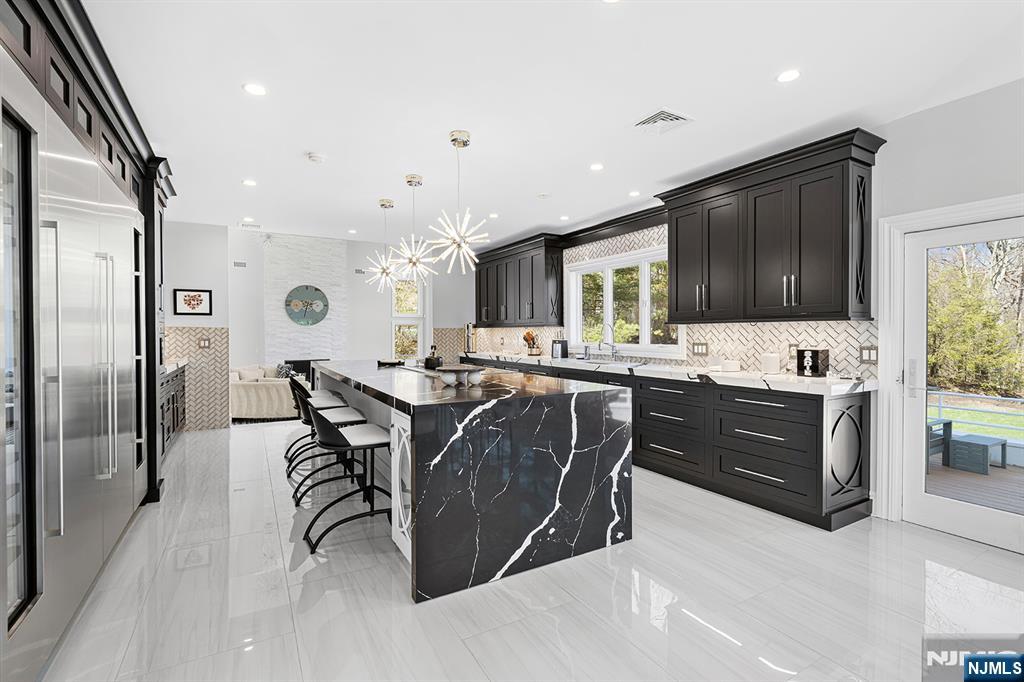 817 West Shore Drive Butler, NJ 07405 - Photo 14 of 50 a living room with stainless steel appliances kitchen island granite countertop a refrigerator a sink a stove and a dining table with wooden floor