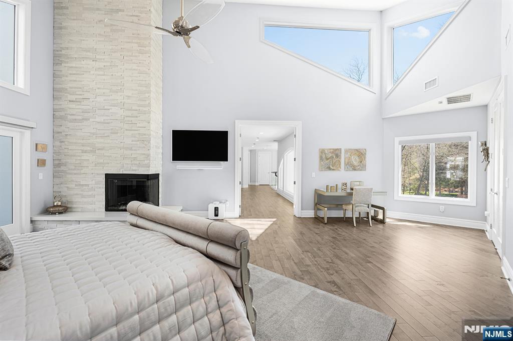 817 West Shore Drive Butler, NJ 07405 - Photo 22 of 50 a spacious bedroom with a bed a couch and large window
