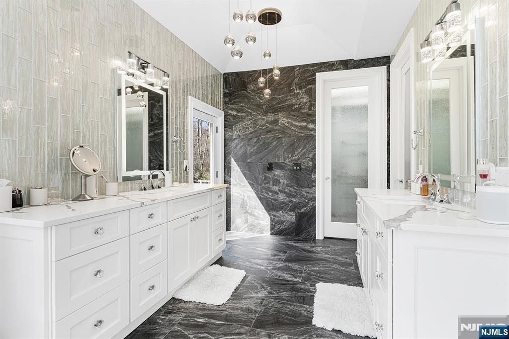 817 West Shore Drive Butler, NJ 07405 - Photo 26 of 50 a bathroom with a double vanity sink mirror and shower